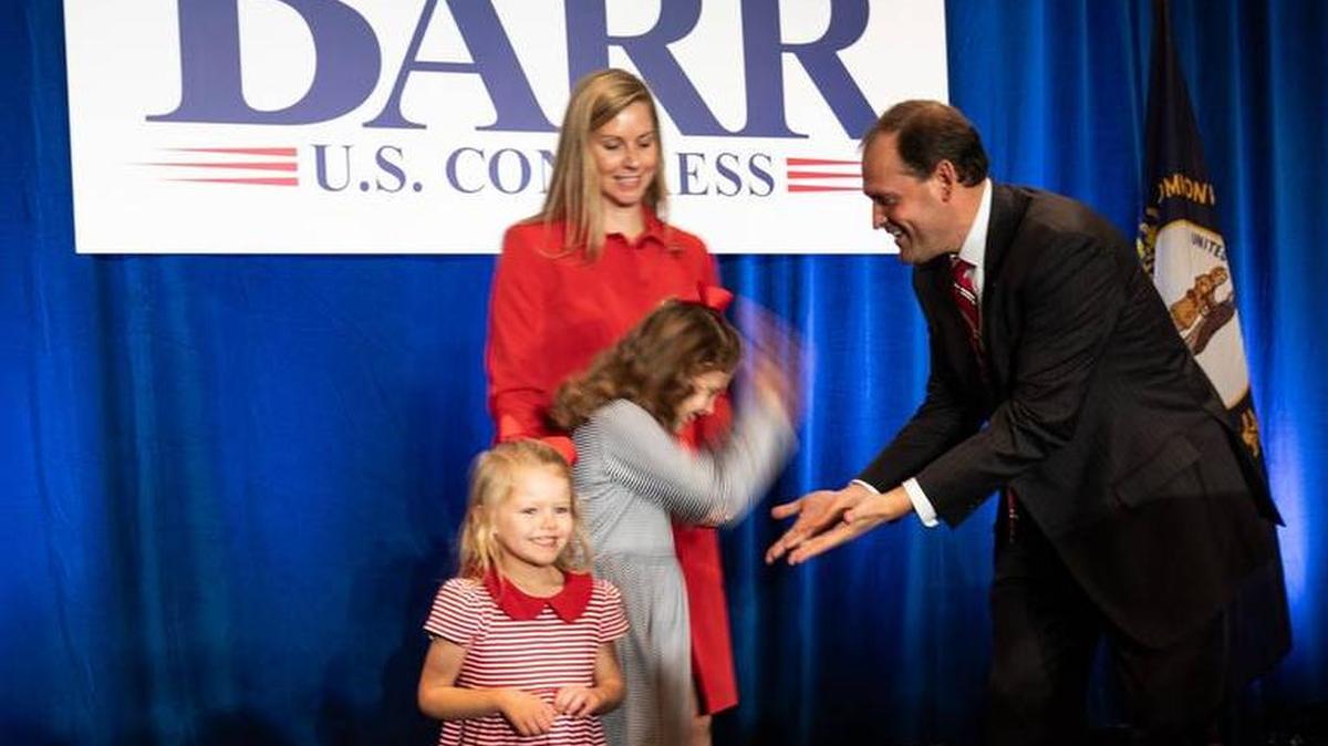 Congressman Andy Barr slapped hands with daughter Eleanor to celebrate his re-election the evening of Nov. 6. as daughter Mary Clay and wife Carroll shared the moment.