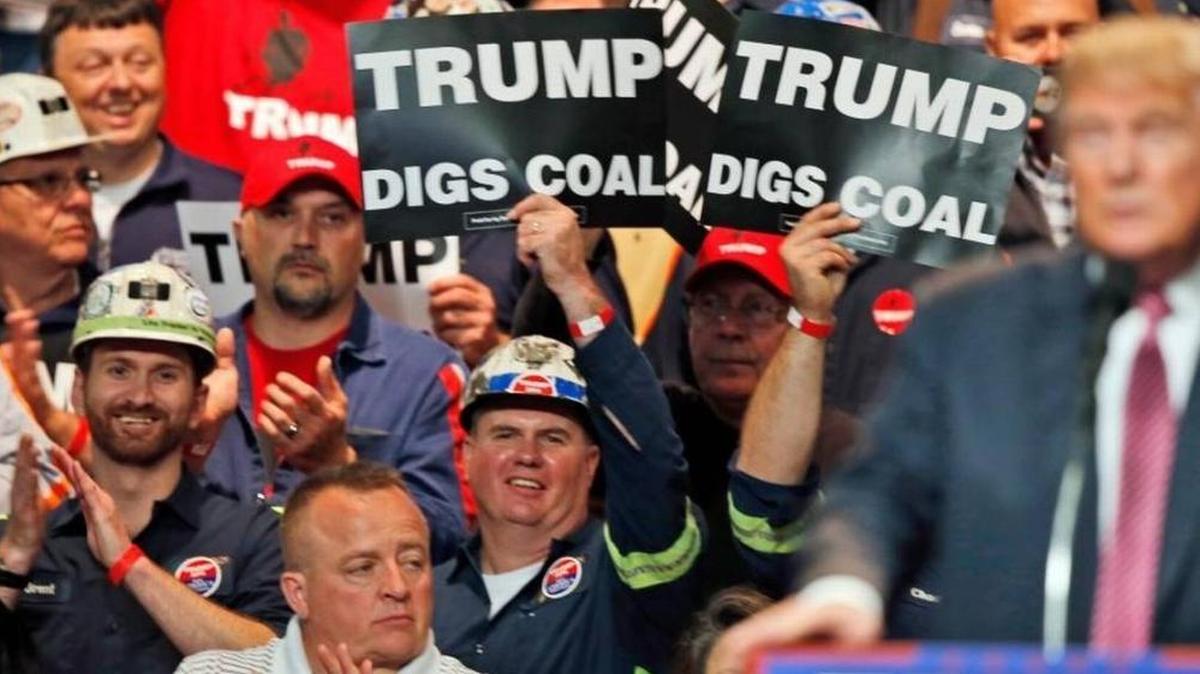 Coal miners waved signs as Donald Trump spoke during a 2016 rally in Charleston, W.Va.
