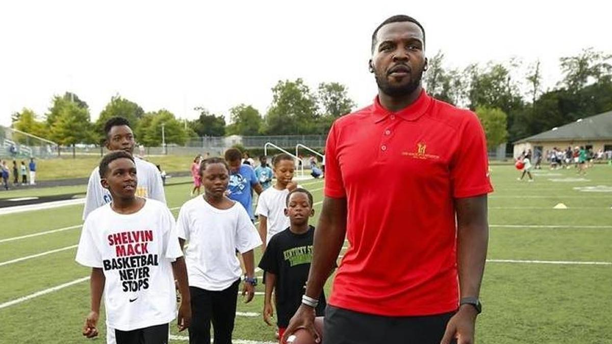 Children gathered around Bryan Station graduate and current Orlando Magic player Shelvin Mack before a game of catch during a back-to-school party in on July 27.