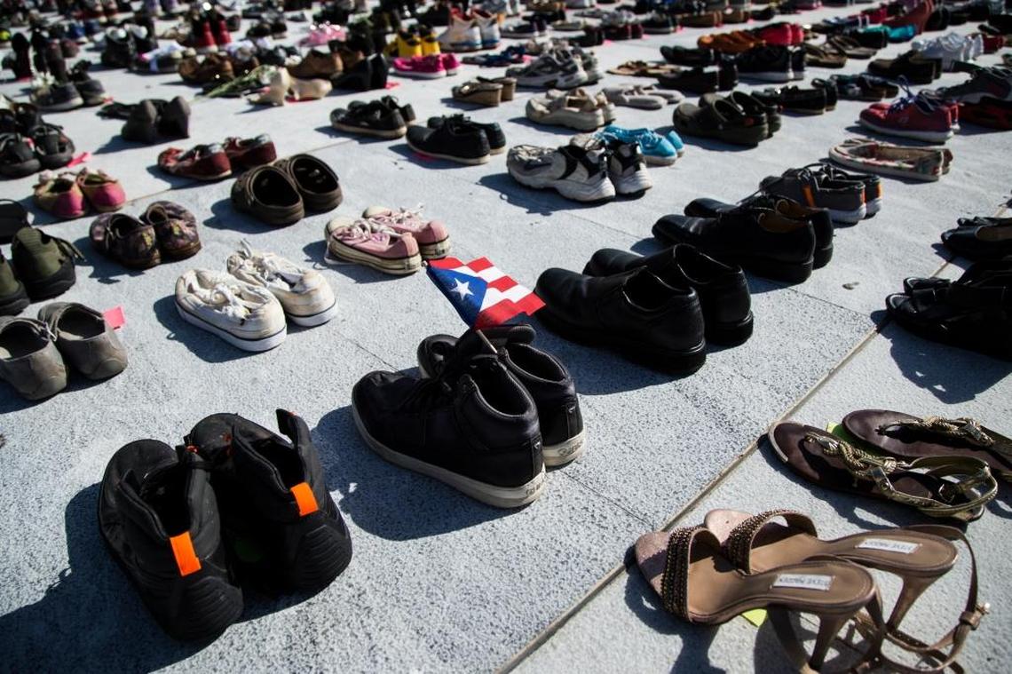 A Puerto Rican flag inside a pair of shoes at a makeshift memorial for the victims of Hurricane Maria, in San Juan, Puerto Rico, on June 1, 2018. In a report to Congress requesting recovery funds, the government acknowledged that 1,427 people died in Hurricane Maria. The official death toll was 64. An independent investigation put the death toll at 2,975 this week.