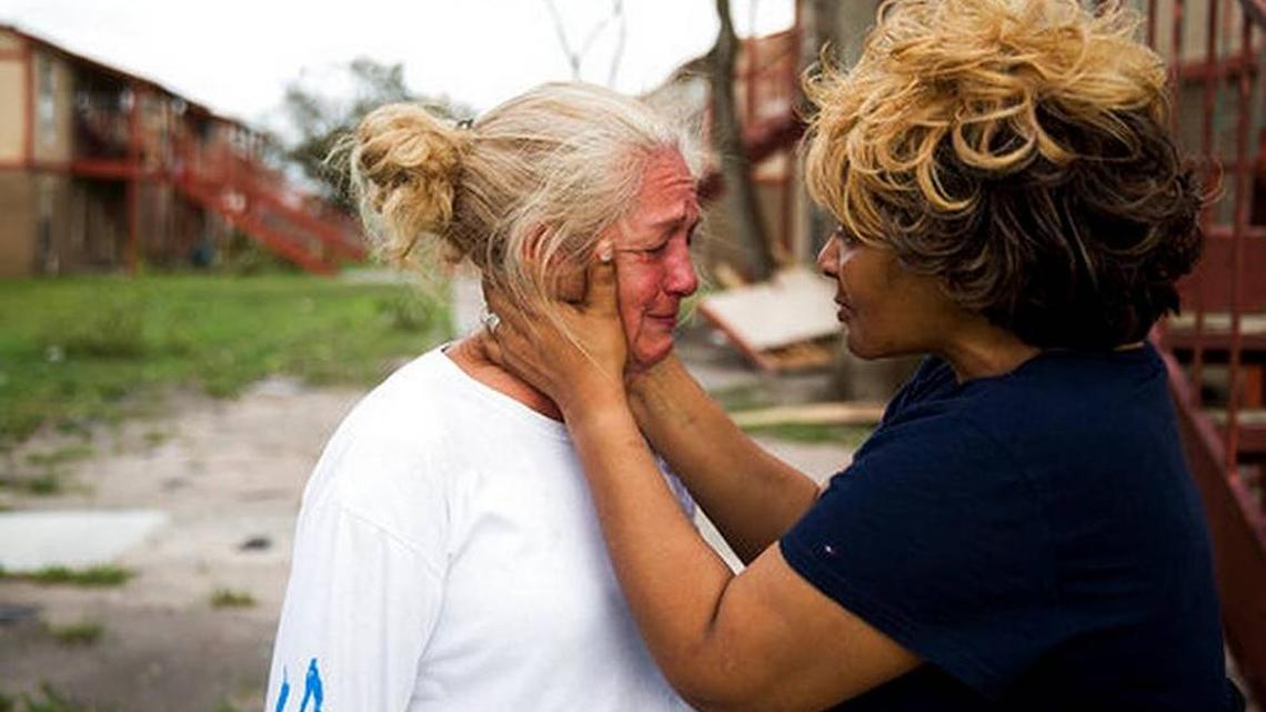 Genice Gipson comforts her lifelong friend, Loretta Capistran, outside of Capistran's flood-damaged apartment complex in Refugio, Texas, on Aug. 28.
