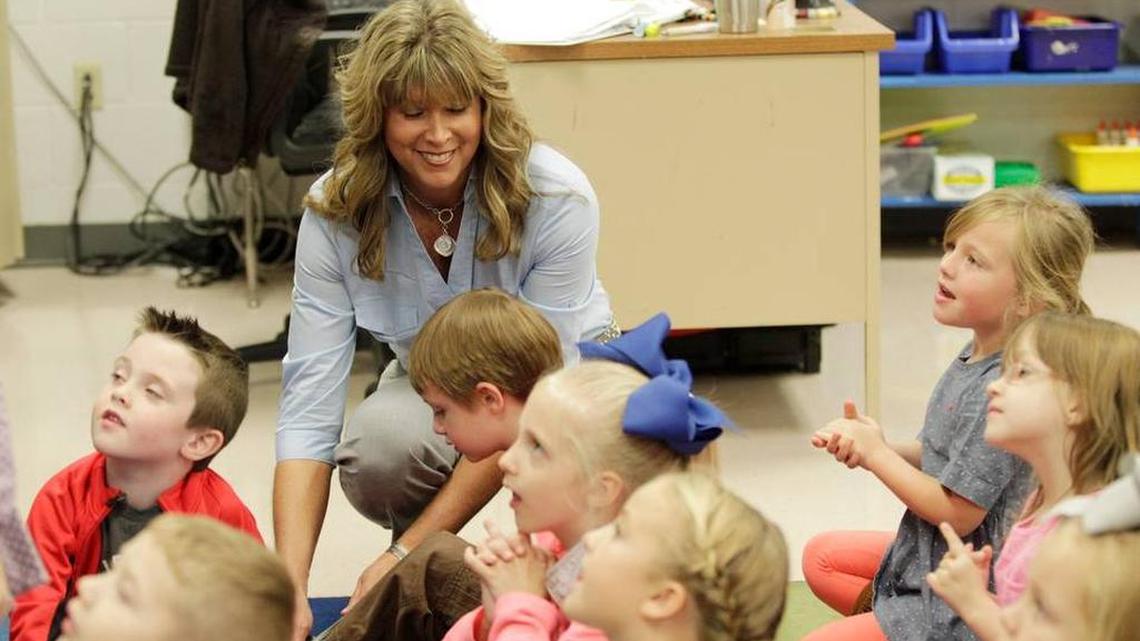 A kindergarten class in Floyd County, one of Kentucky’s many education success stories. May Valley Elementary principal Greta Thornsberry helped Vincent Osborne with his shoelaces in 2015.