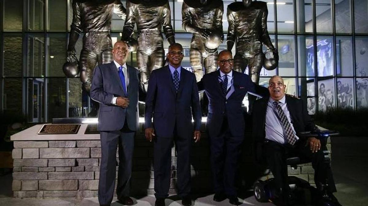 Last year, the University of Kentucky unveiled at its stadium statues of four football players who broke the SEC color barrier in 1967. From left: Mel Page, representing his dad Greg Page, Nate Northington, Wilbur Hackett and Houston Hogg.