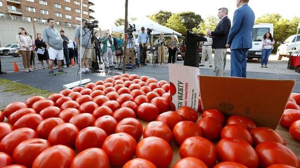 Kentucky Agriculture Commissioner Ryan Quarles, with Lexington Mayor Jim Gray at right, spoke June 27, 2017 during the Kentucky Double Dollars Program announcement at the farmers market, at South Broadway and West Maxwell Street in Lexington Double Dollars enables people who receive government nutritional assistance to double their spending power at farmers markets.