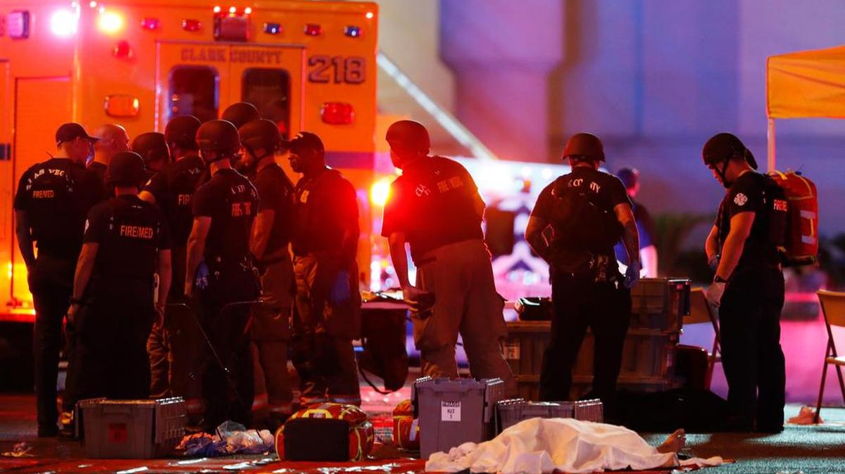 A body was covered with a sheet after a mass shooting in which dozens were killed at a music festival on the Las Vegas Strip Sunday, Oct. 1.