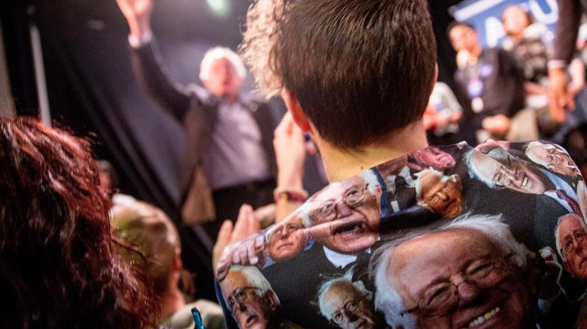 Adam Peters of Iowa City, Iowa, wore a shirt depicting Democratic presidential candidate Sen. Bernie Sanders, D-Vt., as Sanders waved goodbye following a speech in Muscatine, Iowa.