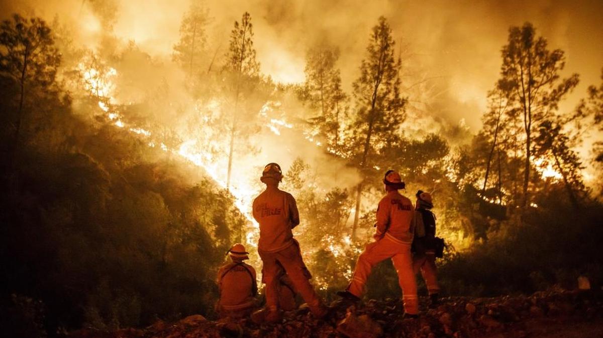 Firefighters monitor a burn operation on top of a ridge near the town of Ladoga, Calif., on Aug. 7.