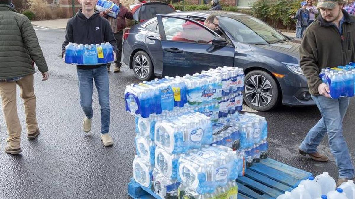 Volunteers stacked donated water for Martin County residents, many of whom are afraid to drink the water from their taps.