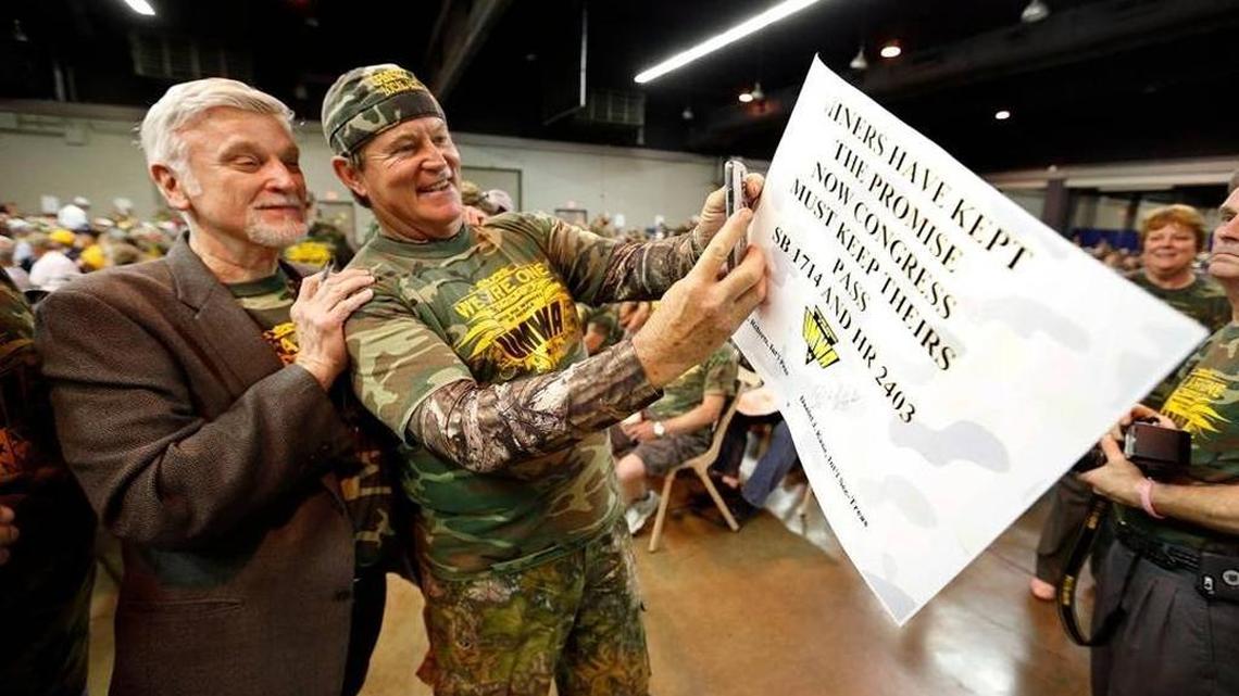 United Mine Workers president Cecil Roberts, left, had his photo taken with one of the 3,500 current and former union coal miners who rallied in Lexington in June to push proposals to shore up union health and pension funds.