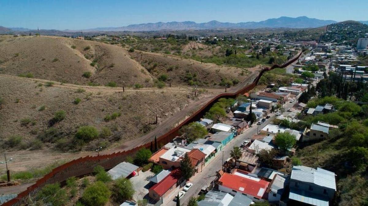 The U.S. Mexico border fence cuts through the two downtowns of Nogales.