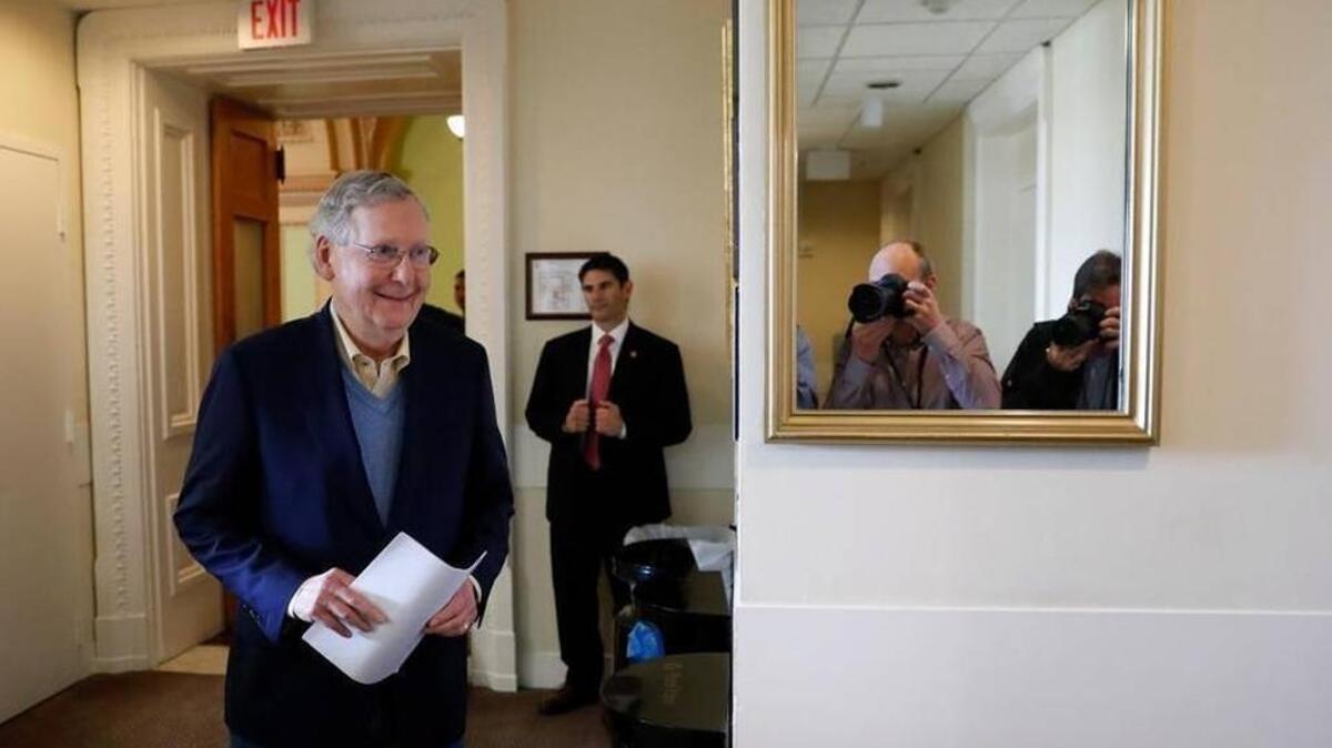 A smiling Sen. Mitch McConnell arrives for a post-election news conference on Capitol Hill Wednesday.