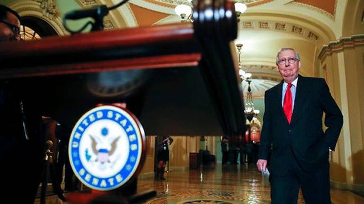 Senate Majority Leader Mitch McConnell of Kentucky walks to the microphone to talk with the media after Senate Republicans met with President Donald Trump on Capitol Hill Tuesday to advance their plans for a tax code overhaul.