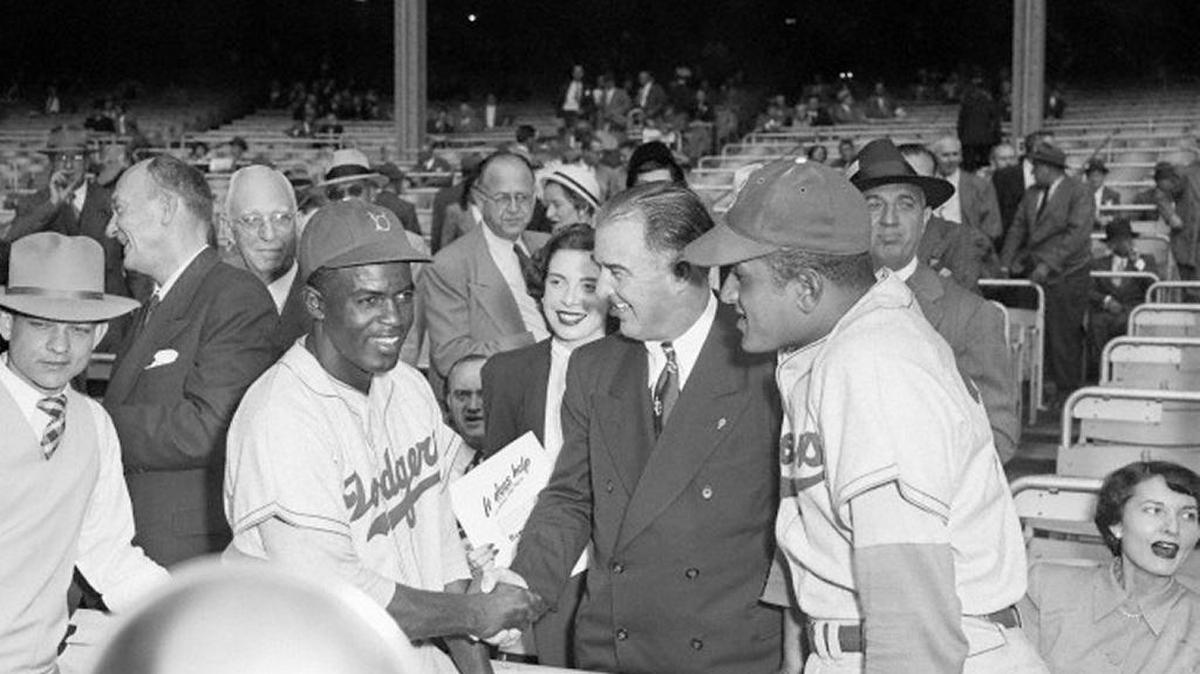 Happy Chandler shook hands with Jackie Robinson at the 1949 World Series.