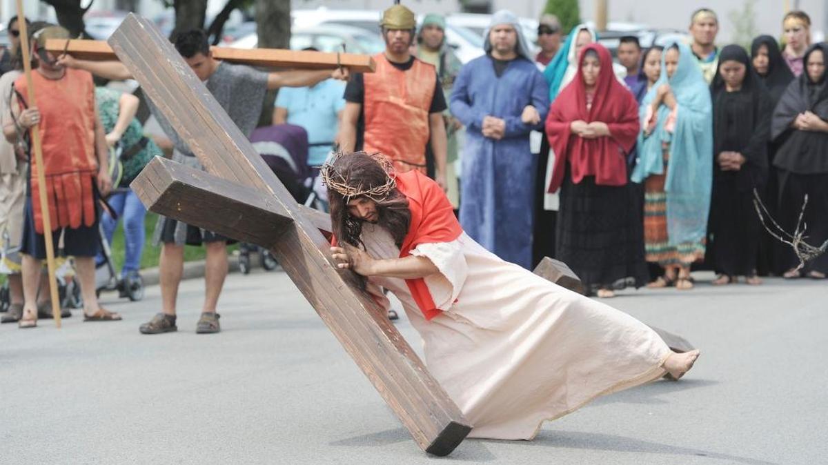 Francisco Morales, playing Jesus, fell as he carried his wooden cross during the Way of the Cross on along Bolivar Street in Owensboro. The procession, which started at St. Joseph and Paul Catholic Church and went to Brescia University, was hosted by the Hispanic community of the church in observance of Good Friday.