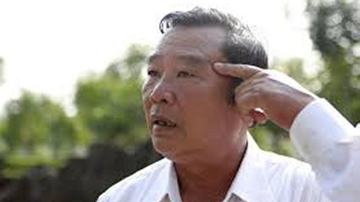 Survivor Pham Thanh Cong points to a scar from grenade fragments during the My Lai massacre at a March 14, 2018 event in Vietnam.