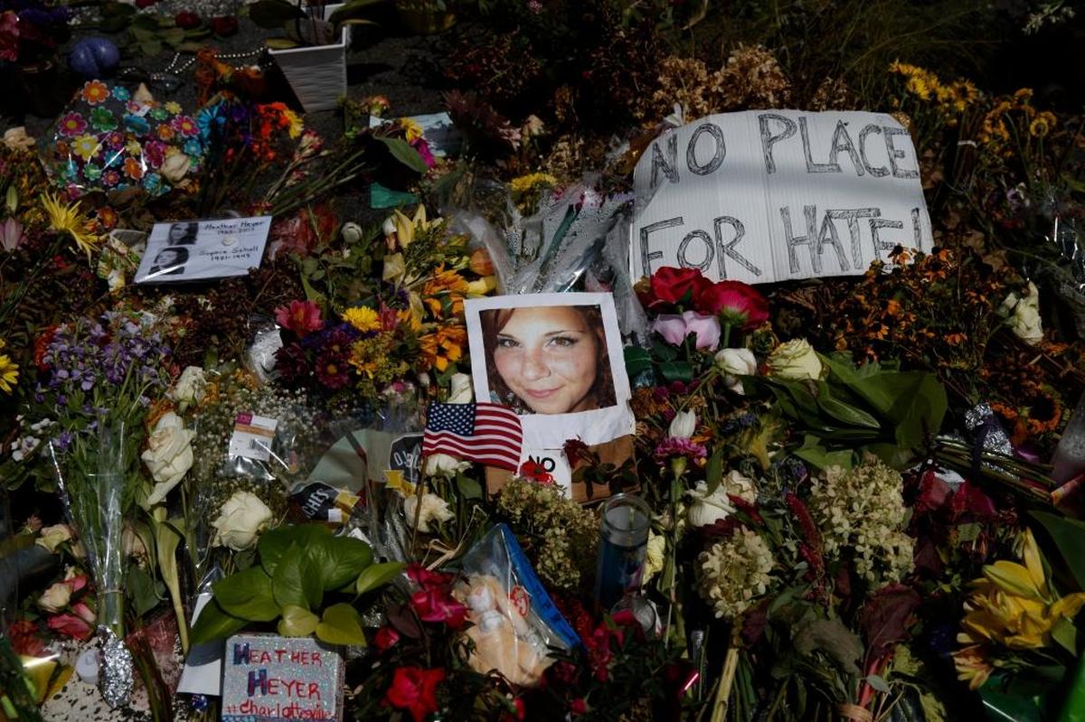 A photo of Heather Heyer, who was killed during a white nationalist rally, sits on the ground at a memorial Wednesday, the day her life was celebrated at the Paramount Theater in Charlottesville, Va.