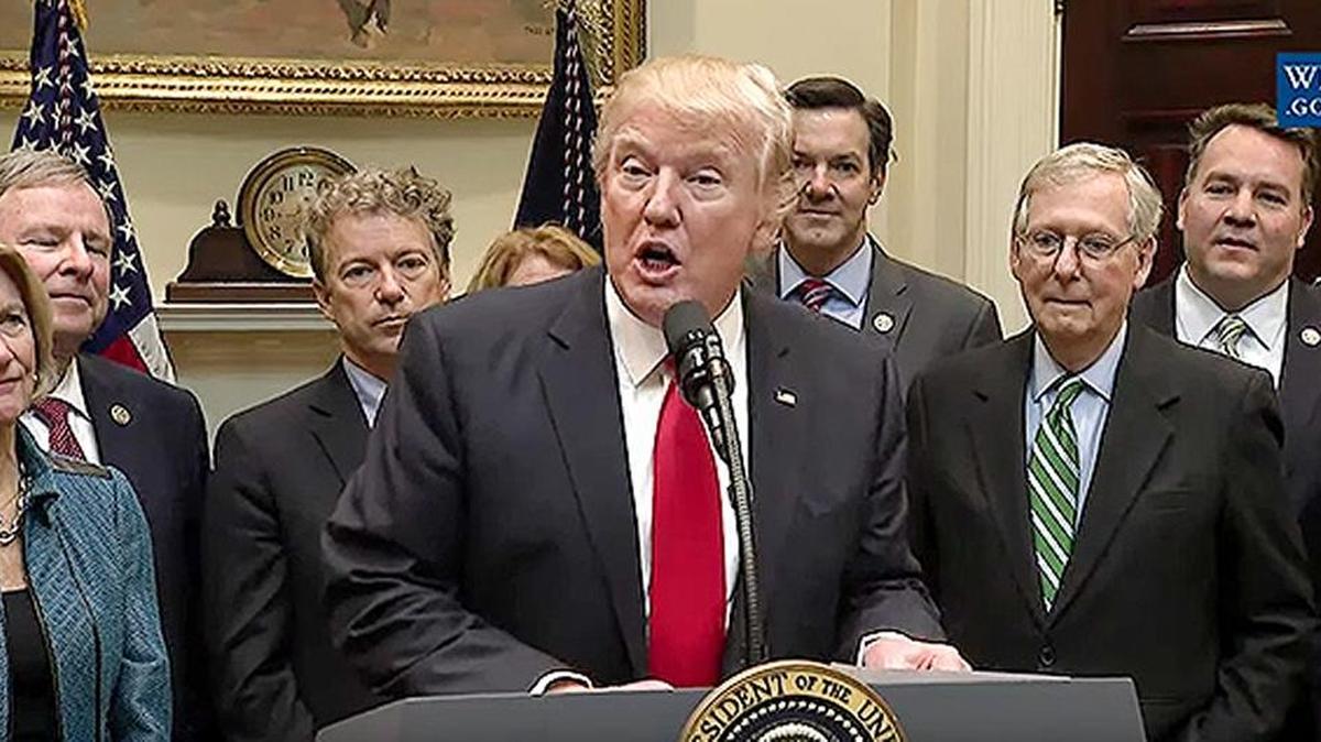 Kentucky Sens. Mitch McConnell, second from right, and Rand Paul, third from left, were among the coal-state lawmakers at the White House Thursday as President Donald Trump signed a resolution killing the Stream Protection Rule.