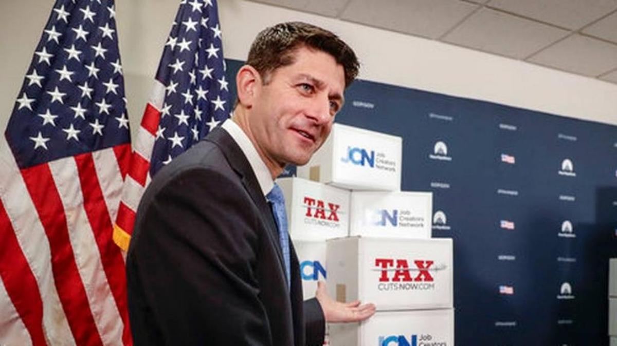 Speaker of the House Paul Ryan, R-Wis., points to boxes of petitions supporting the Republican tax reform that the House has approved.