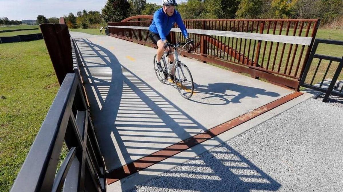 A bike rider crossed one of the bridges on the Legacy Trail in 2013. Fund-raising for the 16-mile bike/walk trail was led by the Bluegrass Community Foundation.