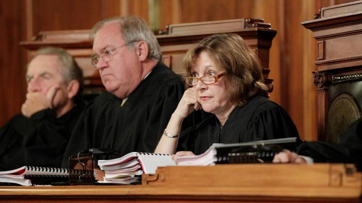 Retired Justice Daniel Venters, center, is flanked by justices Bill Cunningham, left, and Lisabeth T. Hughes in this file photo.