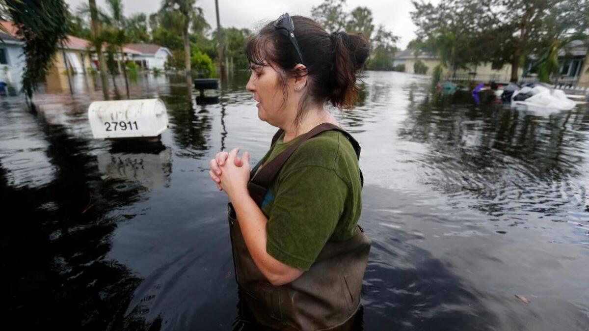 Kelly McClenthen waited outside while her boyfriend checked the inside of her flooded Bonita Springs, Fla., home on Monday in the aftermath of Hurricane Irma.