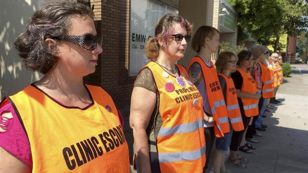 Escort volunteers lined up outside the EMW Women’s Surgical Center in Louisville on July 17.