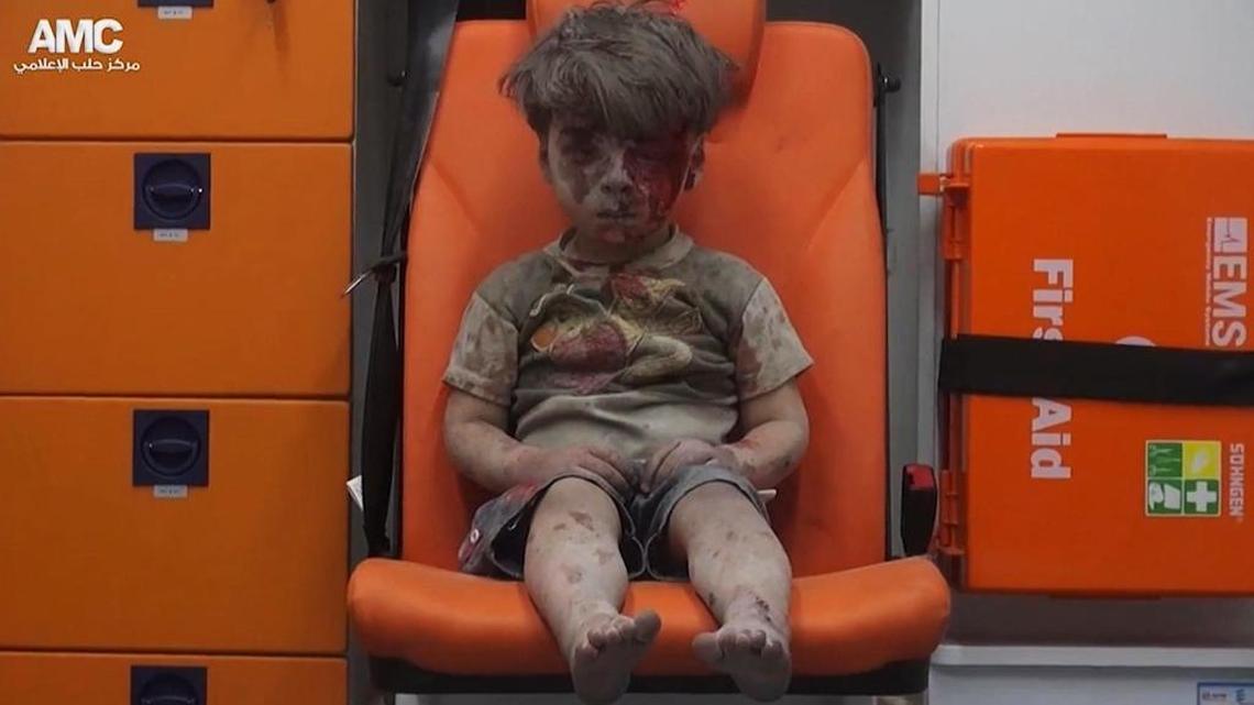 In this Aug. 17 frame grab taken from video provided by the Syrian anti-government activist group Aleppo Media Center, 5-year-old Omran Daqneesh sits in an ambulance after being pulled out of a building hit by an airstrike in Aleppo, Syria.