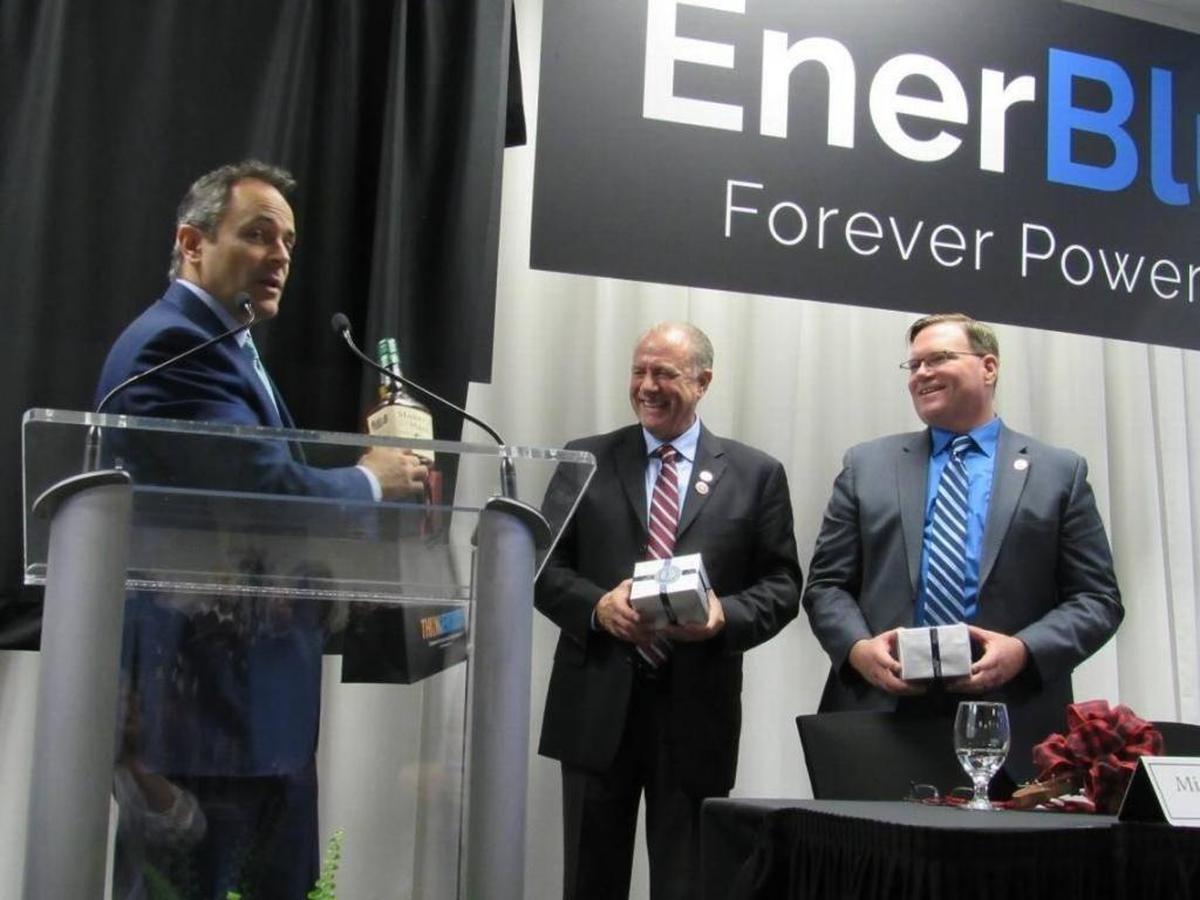 Gov. Matt Bevin, left, presented a bottle of bourbon in December to executives of Enerblu, a company that plans to build a battery-manufacturing plant in Pikeville and a headquarters facility in Lexington. At center is Michael Weber and Daniel Elliott, president and CEO.