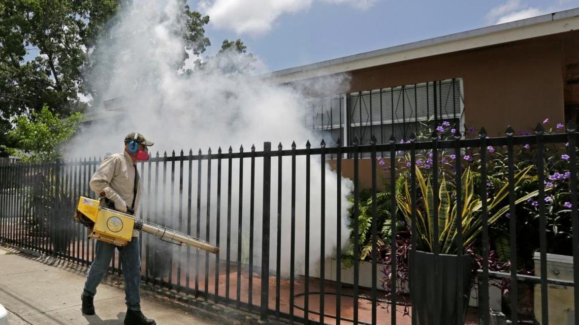 A Miami-Dade County mosquito-control worker sprayed around a Miami home on Monday. Florida officials reported at least 14 cases of the Zika virus, spread by mosquito bites and sexual contact. The Centers for Disease Control has warned pregnant women not to travel to parts part of Miami.