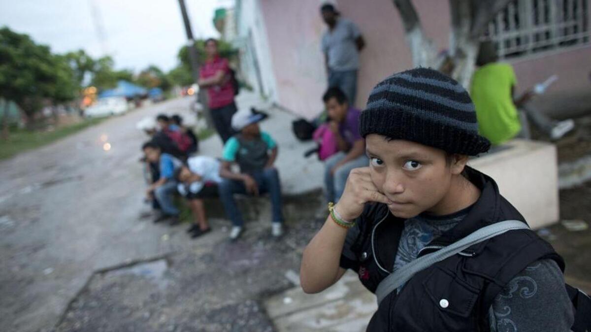 A 14-year-old Guatemalan girl traveling alone in 2014 waited for a northbound freight train along with other Central American migrants in Arriaga, Chiapas state, Mexico.