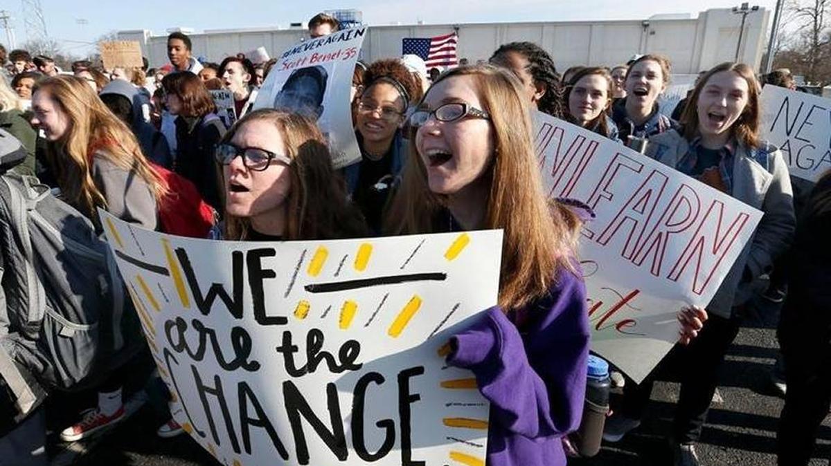 Lafayette High School juniors Maddison Howard, left, and Jasmine Flora, right joined classmates who took part in a nationwide 10 a.m. walkout Wednesday to commemorate the one-month anniversary of the shooting at Marjory Stoneman Douglas High School in Florida and to demonstrate against school violence. The students stayed outside for 17 minutes, one minute for each student killed at at Stoneman Douglas.