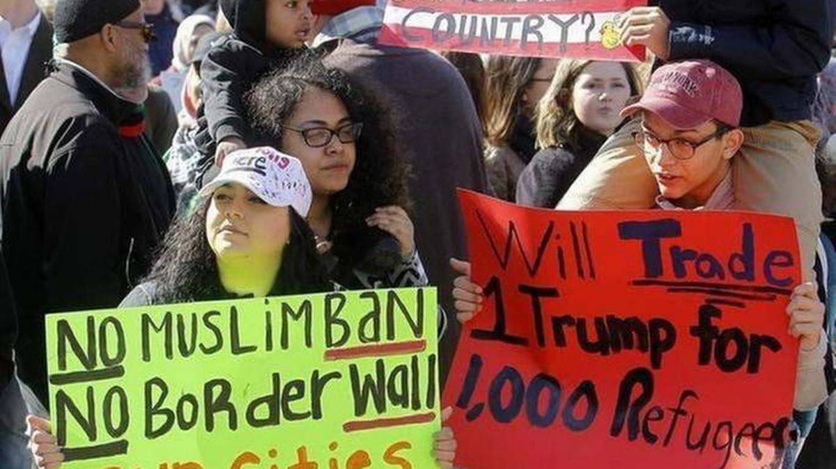 Participants held signs during the Feb. 5 protest against an immigration ban held at Lexington’s Courthouse Plaza.