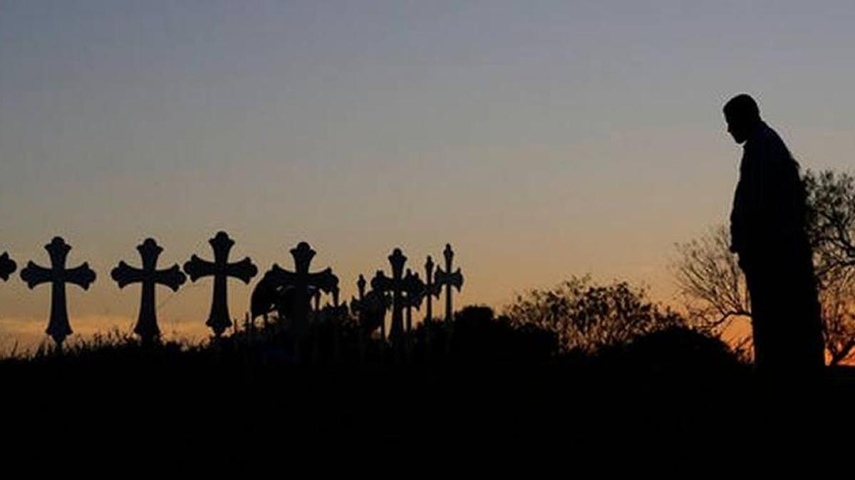 Isaac Hernandez and his wife Crystal visit a line of crosses before a vigil for the victims of the First Baptist Church shooting, Nov. 6, 2017, in Sutherland Springs, Texas. A man opened fire inside the church in the small South Texas community on Sunday, killing more than 20 and injuring others.