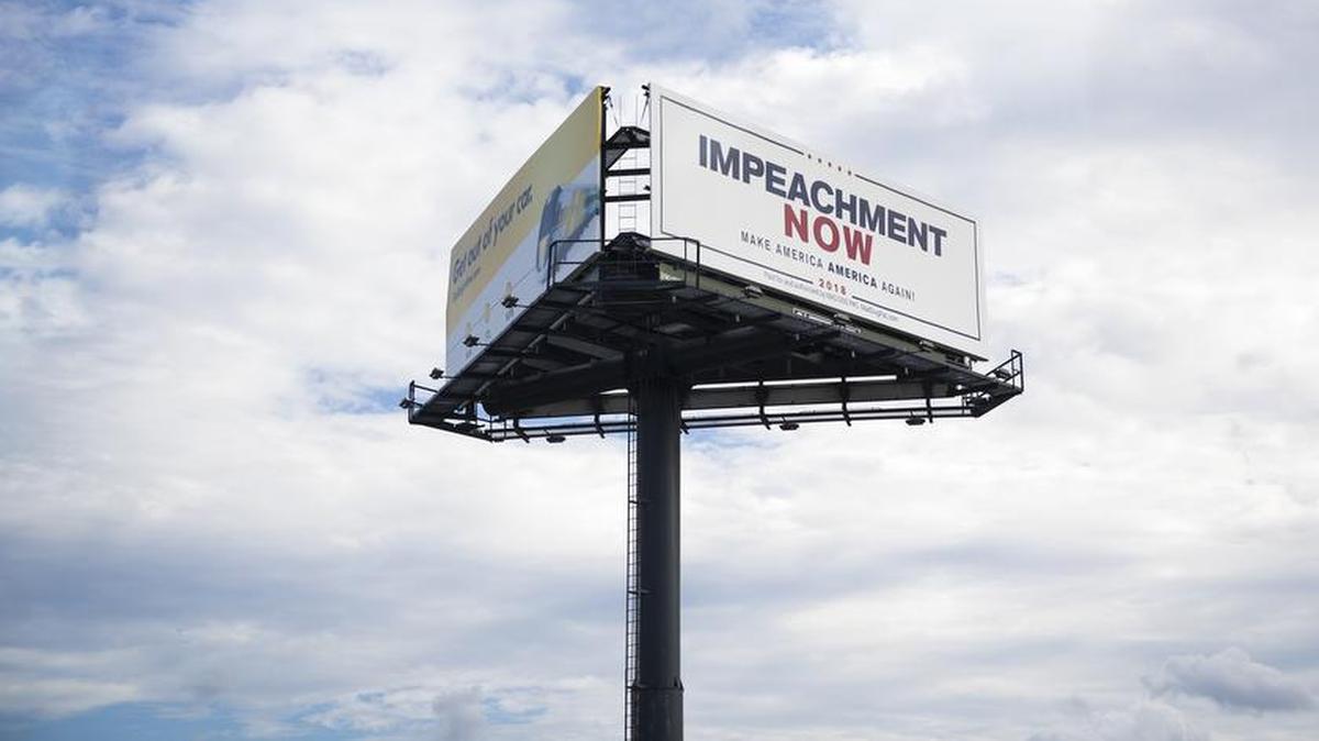 A billboard calling for the impeachment of President Donald Trump was posted Nov. 24 along the route Trump’s motorcade took through West Palm Beach, Fla.