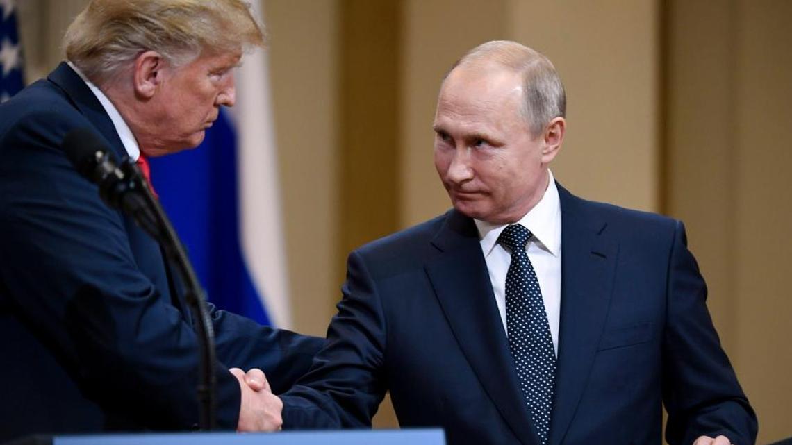 U.S. President Donald Trump and Russian President Vladimir Putin shake hands during a join press conference at the Presidential Palace in Helsinki, Finland, Monday, July 16, 2018. (Antti Aimo-Koivisto/Lehtikuva via AP)
