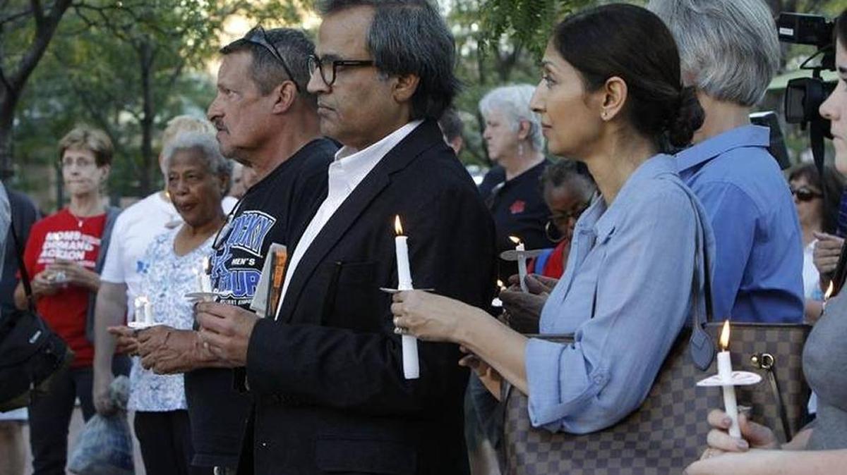 People held candles during a vigil at Triangle Park in Lexington Wednesday to honor the victims of the Las Vegas shooting.