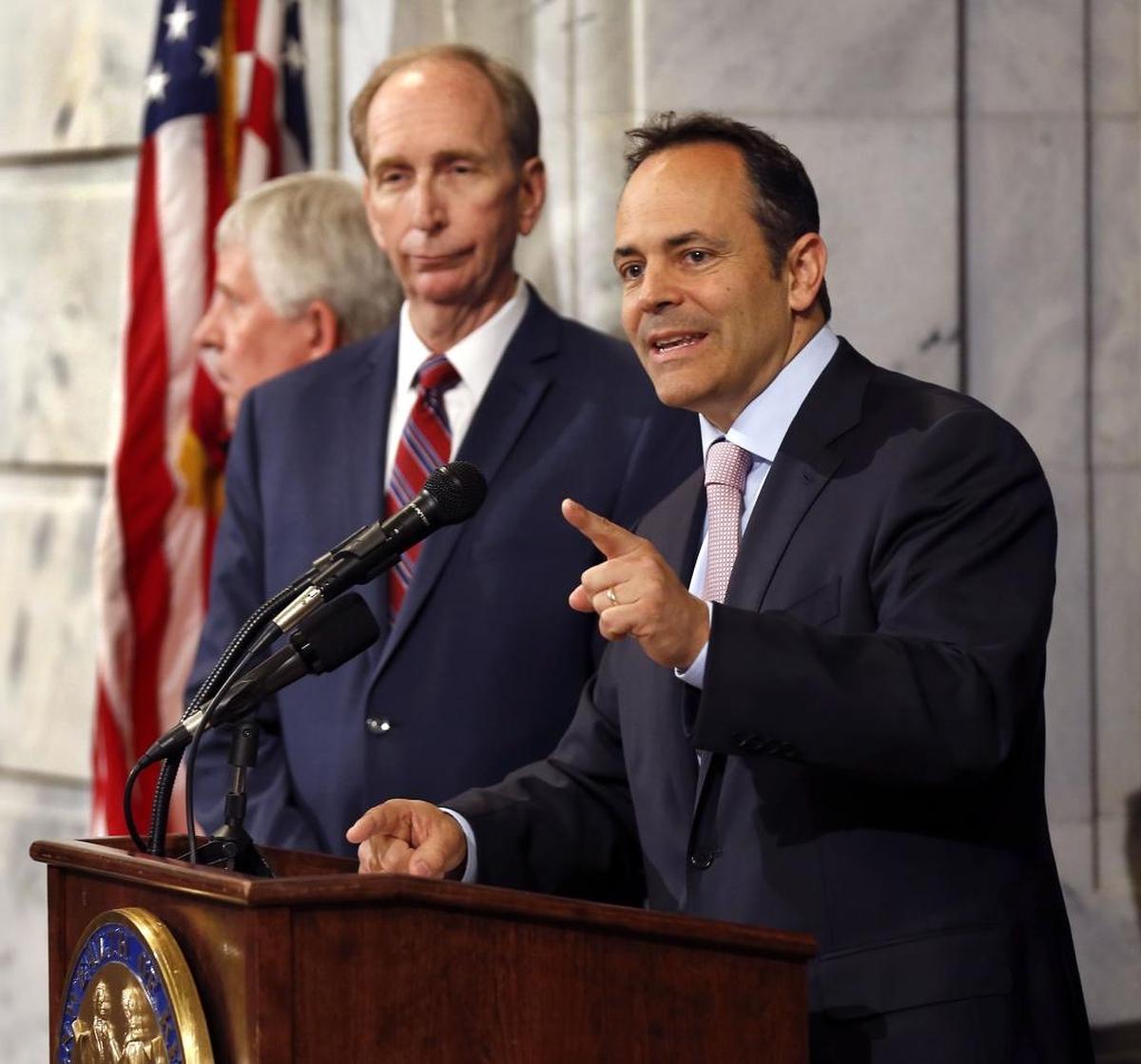 Gov. Matt Bevin, right, unveiled details of his plan to overhaul Medicaid at a news conference in Frankfort.