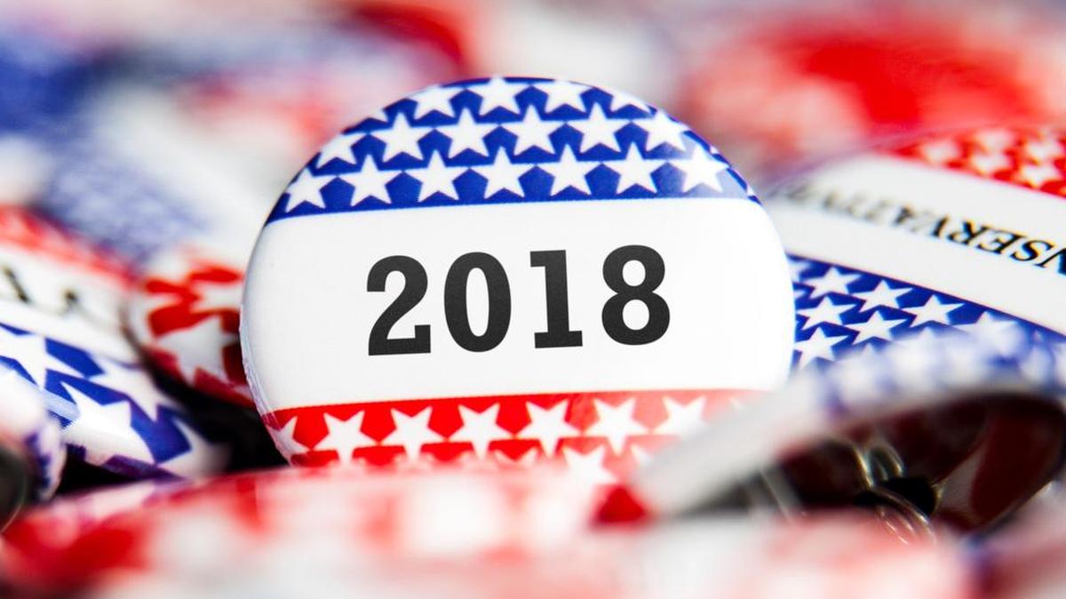 A 2018 Election Vote button on a pile of other buttons