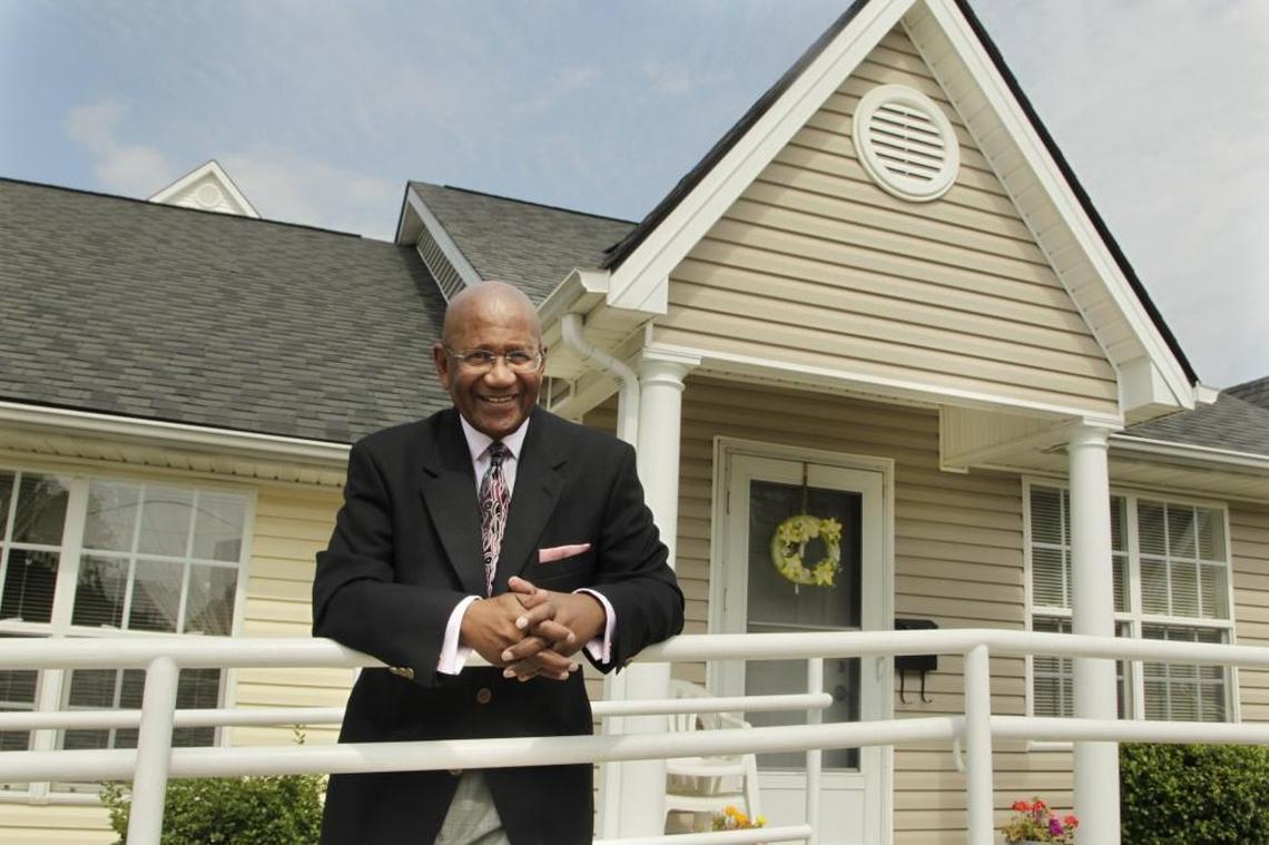 P.G. Peeples, president of Urban League of Lexington-Fayette County, stood in 2013 by new housing the agency constructed on Elm Tree Lane.