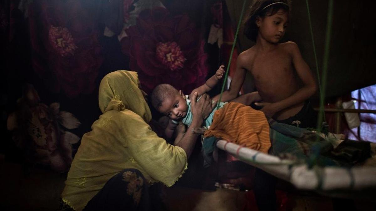 In this June 26 photo, a Rohingya woman in a Bangladesh refugee camp reached for the son born out of a rape by six soldiers from Myanmar's security, after they strangled her two-year-old son to death. Her husband blames her for the rape and wants nothing to do with her or the baby.