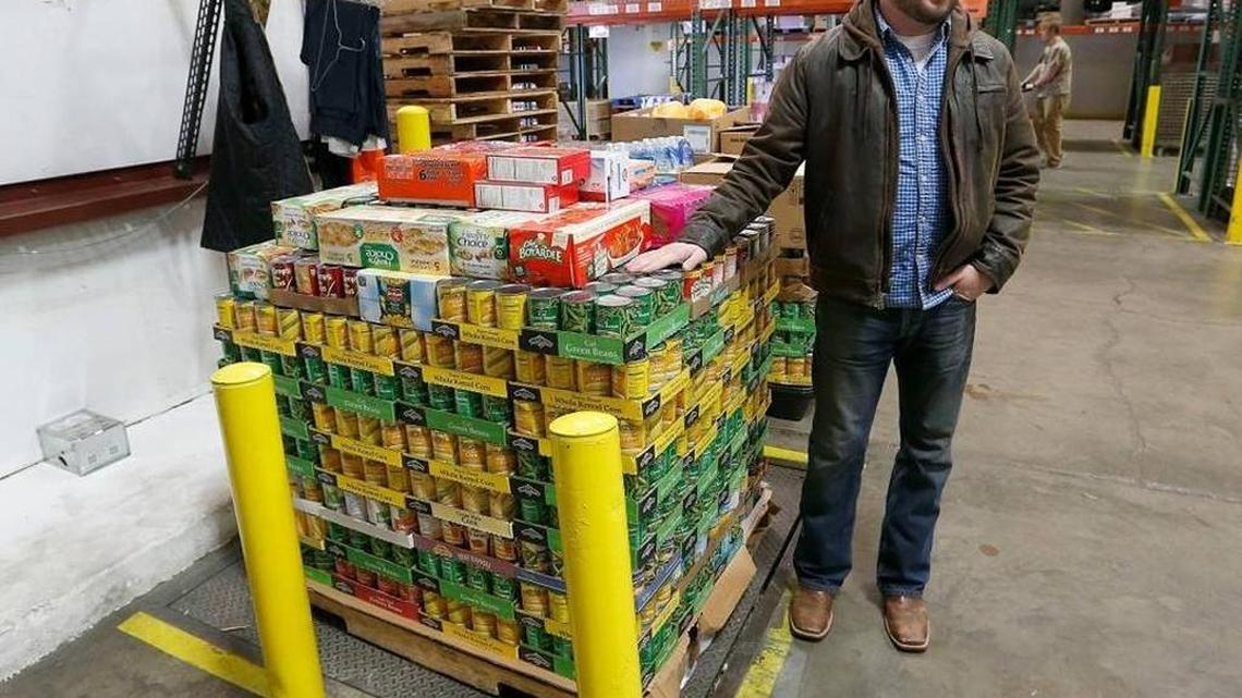 Kentucky Department of Agriculture Commissioner Ryan Quarles stood by pallets of donated food at God's Pantry Food Bank in Lexington on Dec. 28. The department delivered over 3,232 pounds of foods donated by employees.