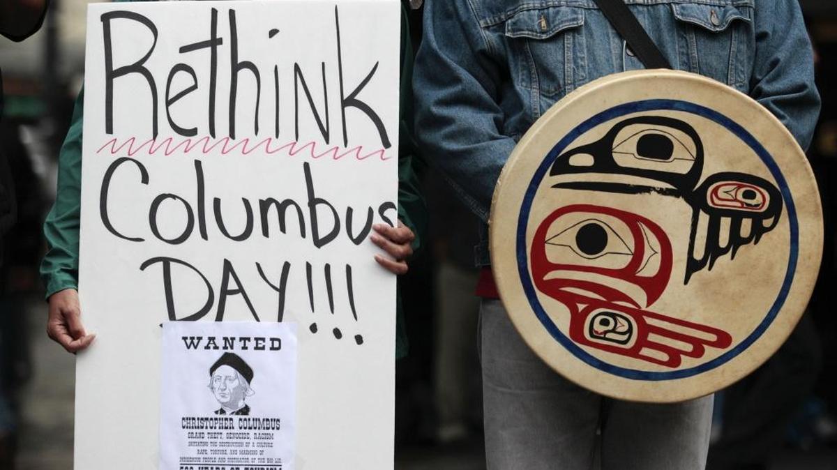 Signs at rally for Indigenous Peoples’ Day in Seattle, which approved the celebration in 2010. This year, Stanford will become the first Kentucky city to hold such a celebration.
