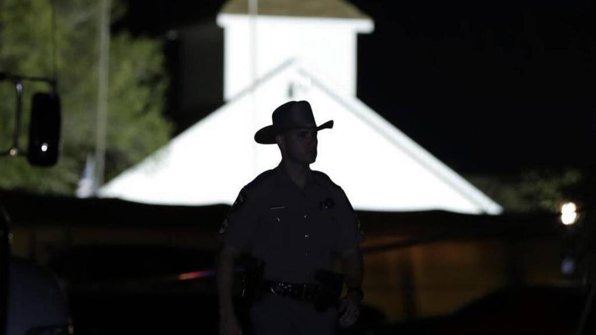 A law enforcement official walks past the First Baptist Church of Sutherland Springs, the scene of a mass shooting, Nov. 5, 2017, in Sutherland Springs, Texas.