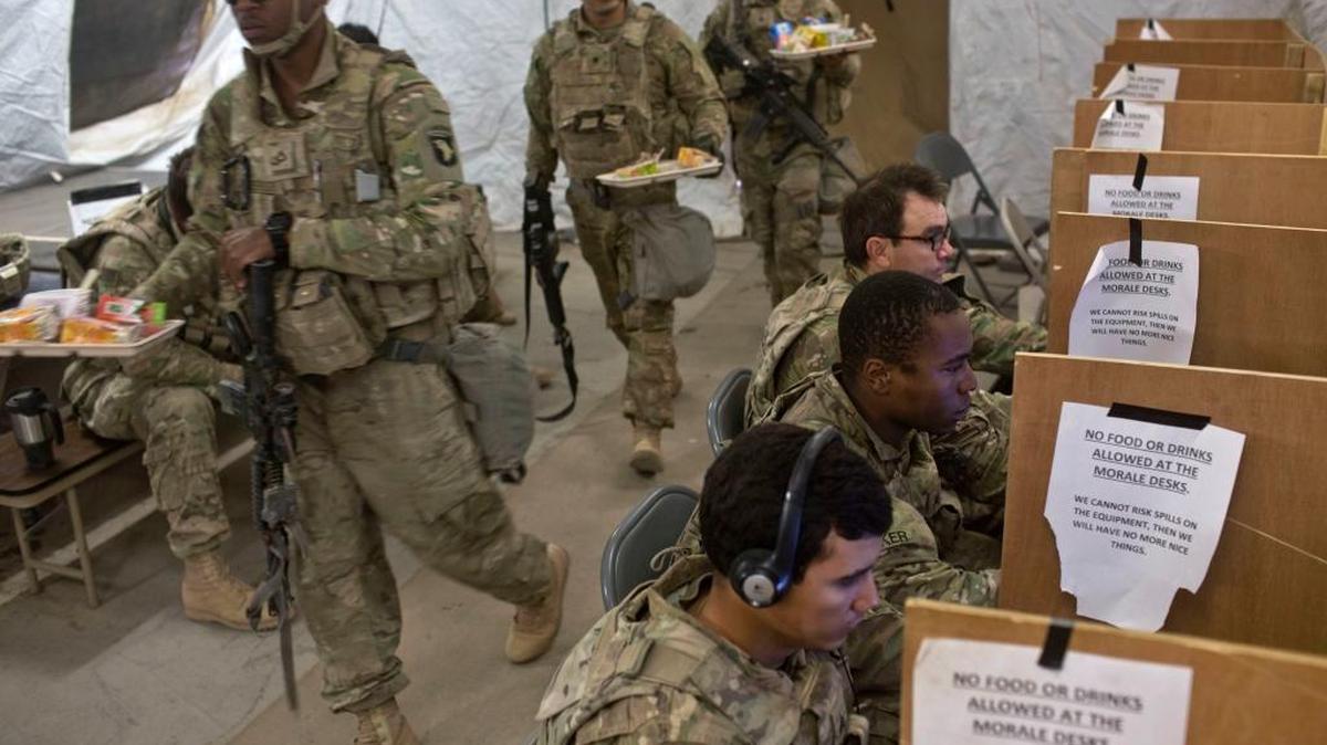 U.S. service members on Friday used computers and prepared to eat inside a tent at a coalition air base in Qayara, south of Mosul, Iraq. The U.S. military says Iraqi forces have retaken 40 villages from the Islamic State group near Mosul since a massive operation to drive the militants from the city began this month.