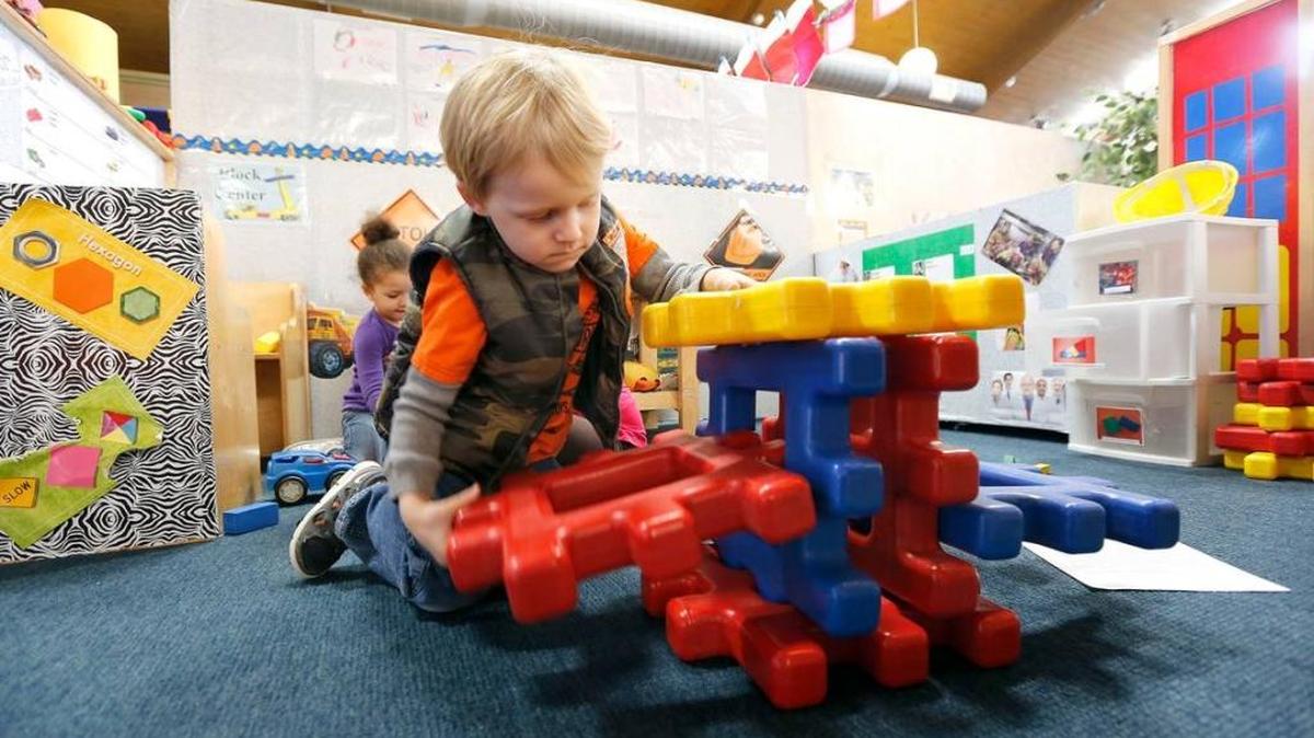Landon Barker built a structure as Aminata Sebor played in the background at the Big Blue Bird Early Childhood Center, 1945 Eastland Pkwy in Lexington, Dec. 18, 2013.