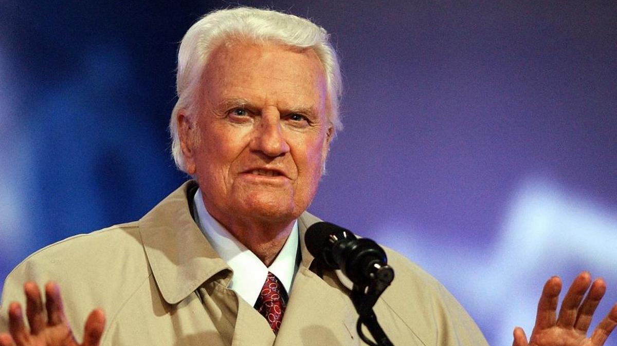 In this 2003 file photo, the Rev. Billy Graham quiets the crowd during the second day of his Mission San Diego revival at Qualcomm Stadium in San Diego. Graham died Feb. 21, 2018, at his home in North Carolina's mountains at age 99.