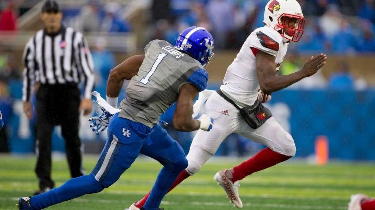 Louisville quarterback Lamar Jackson raced to the edge against Kentucky safety A.J. Stamps in the 2015 regular-season finale in Commonwealth Stadium. Jackson came off the bench to run for 186 yards and two touchdowns in the Cardinals 38-24 victory.