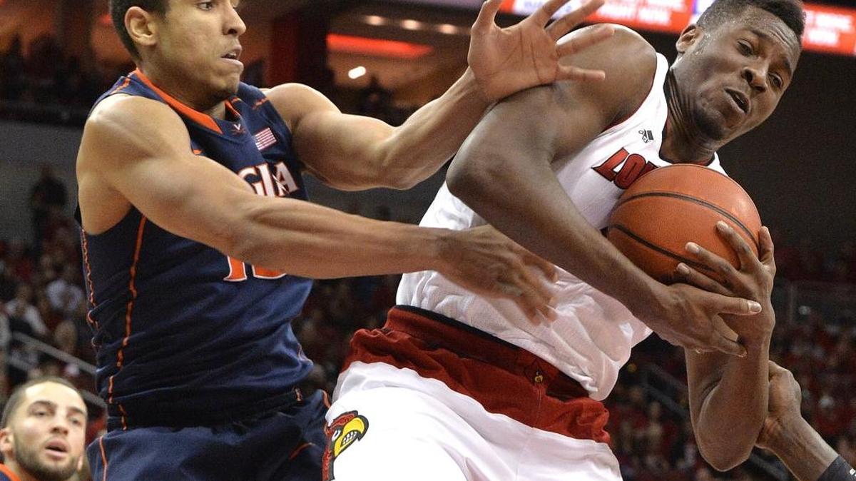 Louisville’s Chinanu Onuaku, right, grabbed a rebound away from Virginia’s Malcolm Brogdon during a game at U of L in March.