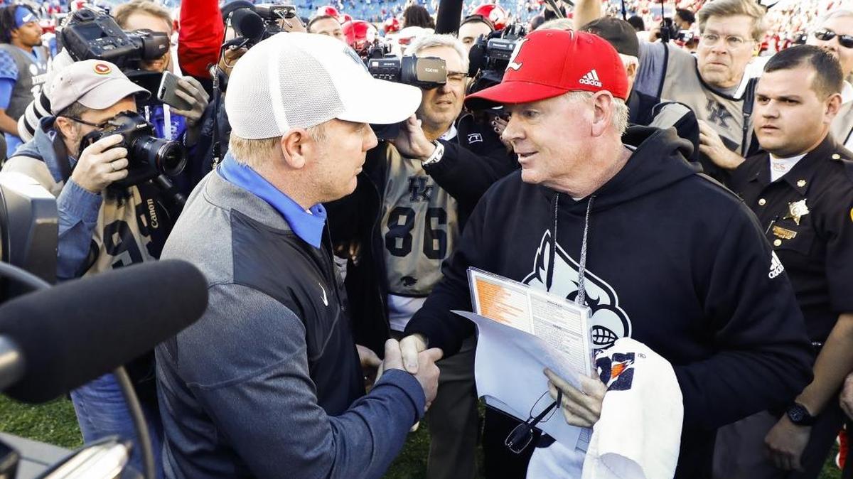 If Kentucky Coach Mark Stoops, left, and Louisville head man Bobby Petrino, right, do not produce strong seasons in 2018, each could begin 2019 with some heat beneath their respective coaching seats?
