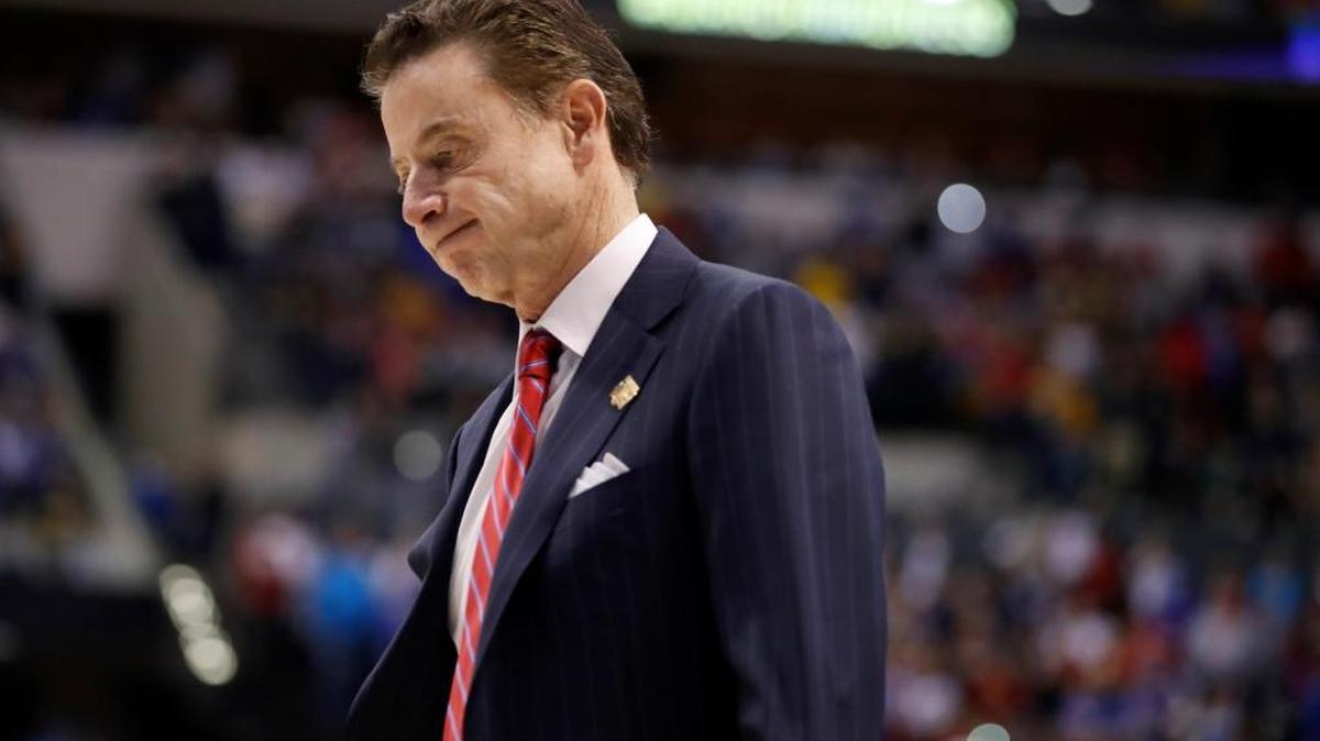 FILE - In this March 19, 2017, file photo, Louisville head coach Rick Pitino walks off the court after a 73-69 loss to Michigan in a second-round game in the men's NCAA college basketball tournament in Indianapolis. The NCAA suspended Pitino, Thursday, June 15, 2017, for five ACC games following sex scandal investigation. A former men's basketball staffer is alleged to have hired strippers to entertain players and recruits. (AP Photo/Jeff Roberson, File)